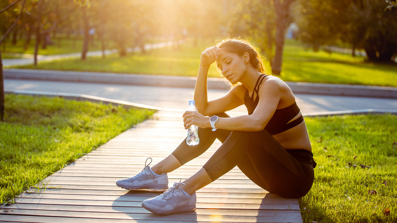 runner drinking water sitting down