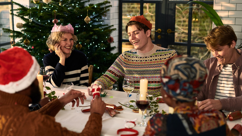 People sitting around a table at a holiday party