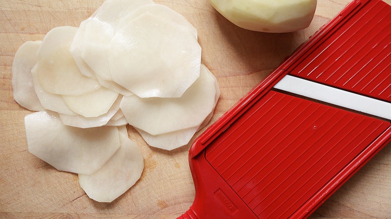potato slices on cutting board 