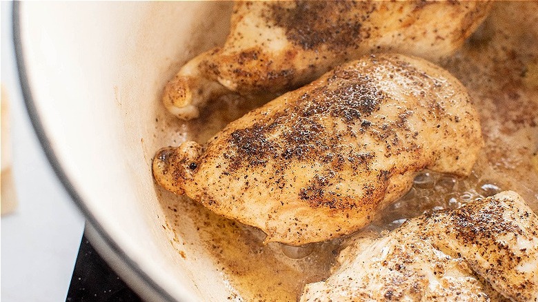 chicken cooking in a pot