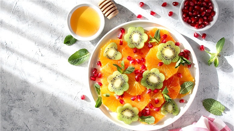 Oranges pomegranate and kiwi with honey