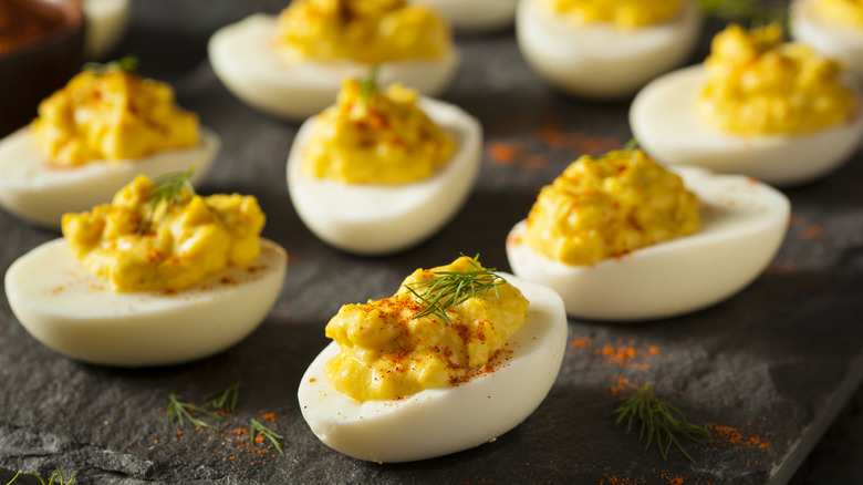 Deviled eggs on dish with herbs