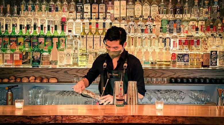 Bartender making drink at Coa