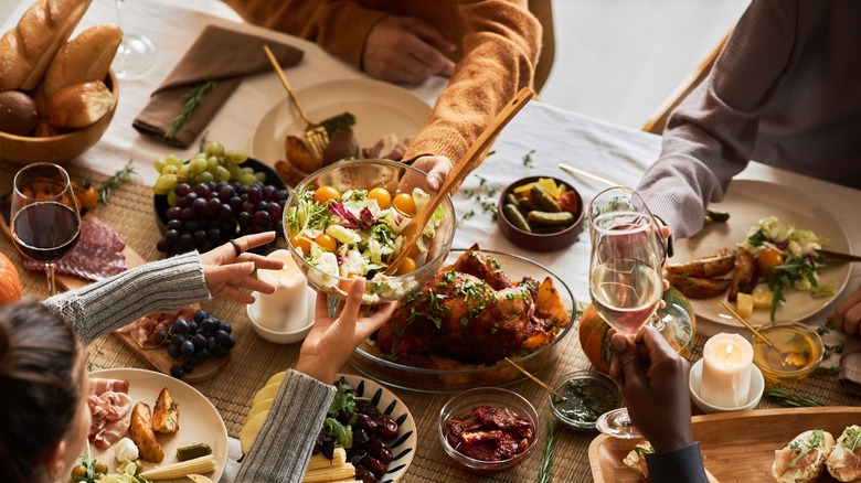 People sharing dinner party spread