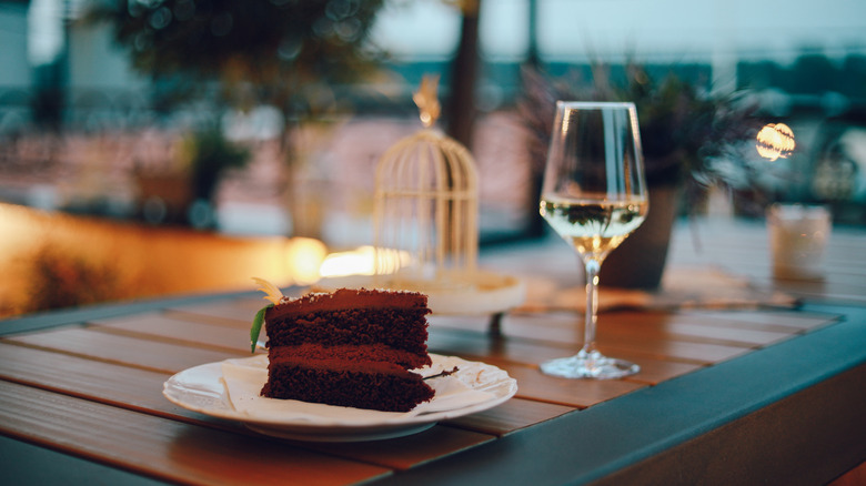 White wine next to chocolate cake