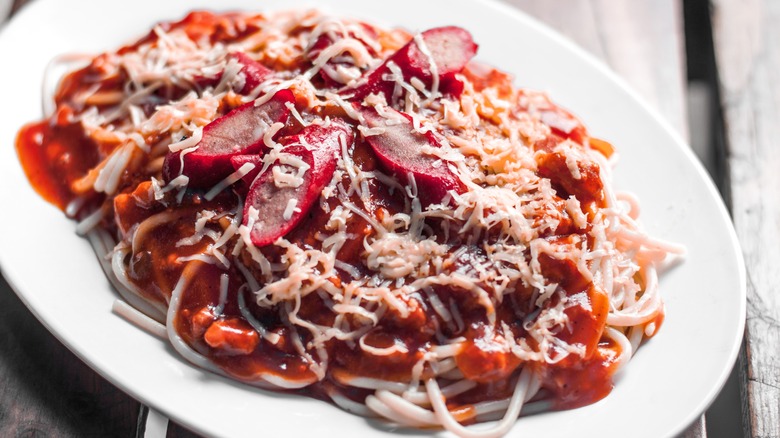 filipino spaghetti topped with filipino hot dogs