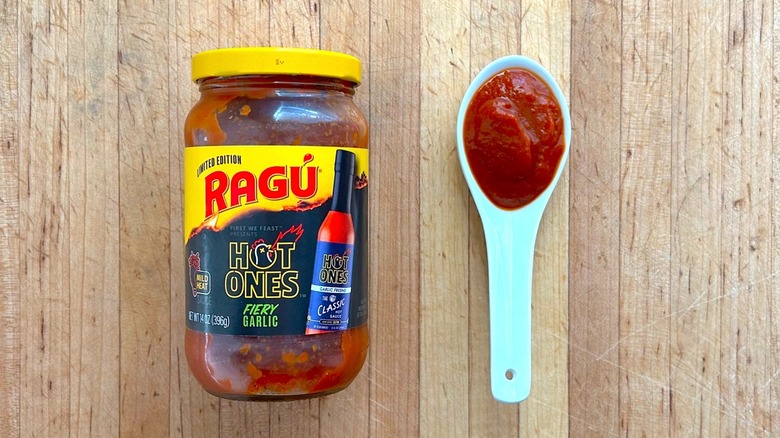 Jar and spoonful of RAGÚ x Hot Ones Limited Edition Fiery Garlic sauce