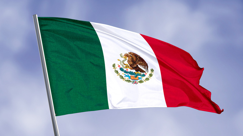 Mexican flag against blue sky