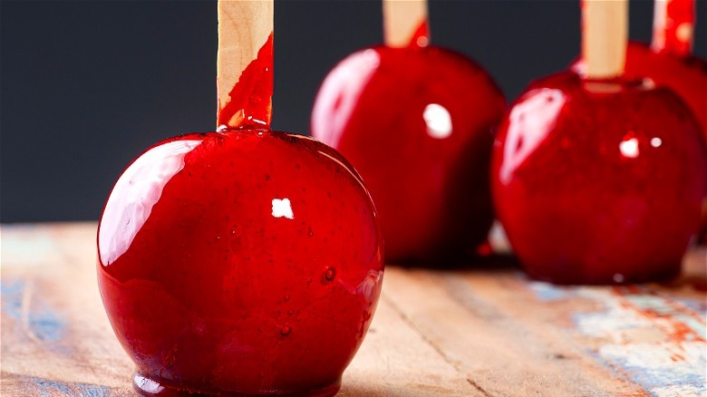 Red candy coated apples on sticks