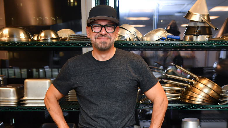 Michael Symon posing with cookware