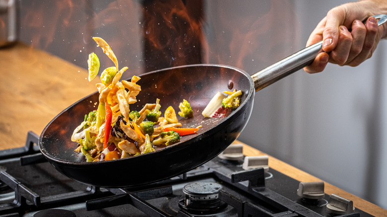 Chef stir-frying vegetables