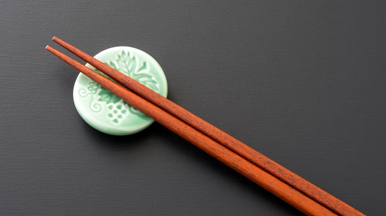 set of wooden chopsticks on a chopstick rest