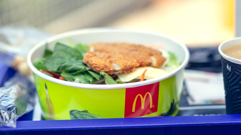 a container of McDonald's chicken salad on a tray