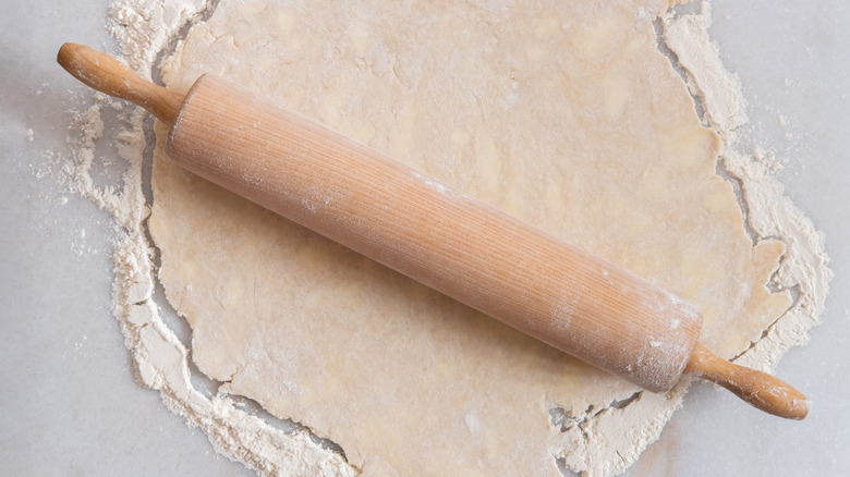 rolling pie dough with rolling pin