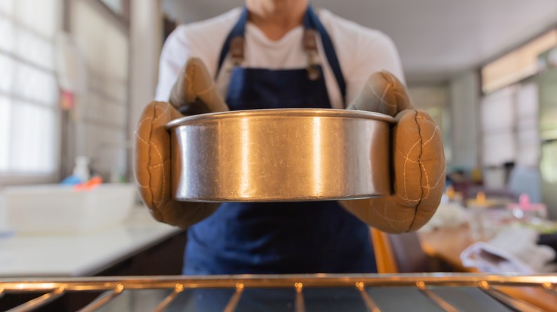 Person holding round cake pan