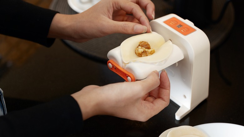 putting dumpling on automatic dumpling maker