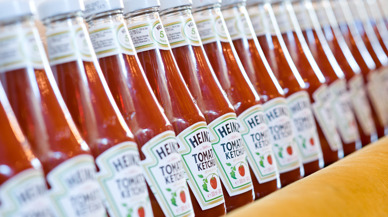 Glass bottles of Heinz ketchup on a shelf