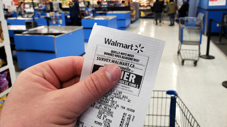 Hand holding Walmart receipt