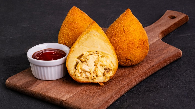 Coxinha cut open with ketchup 