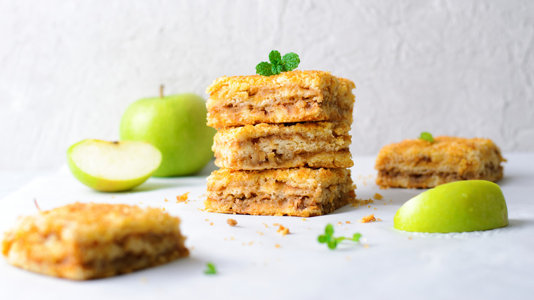 Apple pie cookie bars and green apples.