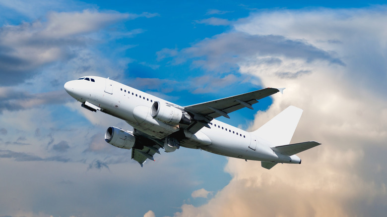 airplane flying in a blue sky