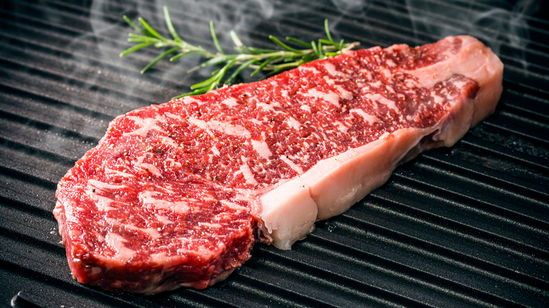 marbled wagyu steak being grilled