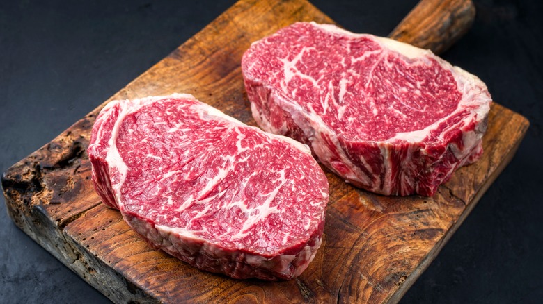 Two wagyu cuts on wooden board