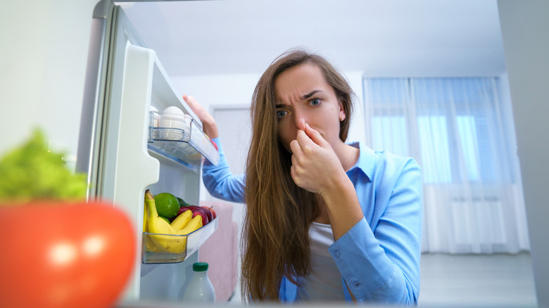 fridge view of person holding nose