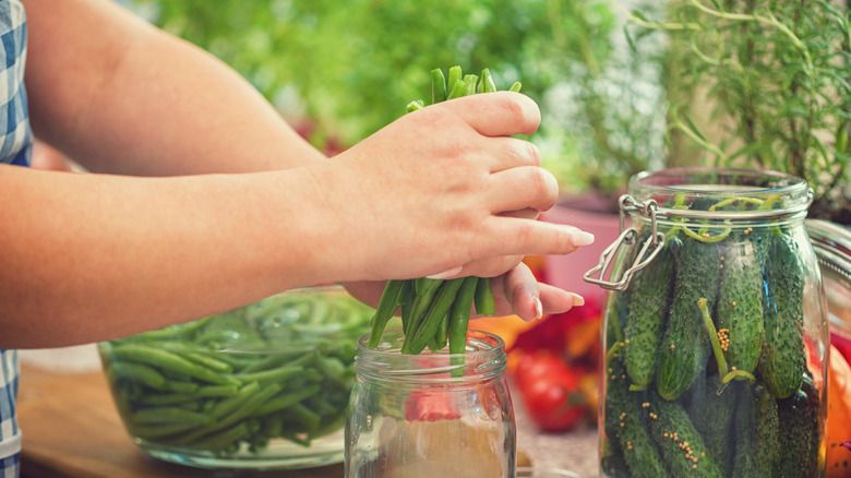 putting green beans in jar