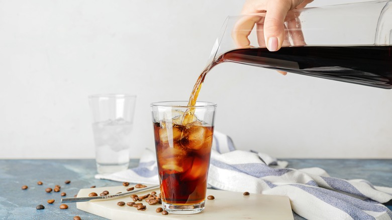 cold brew pouring into glass of ice