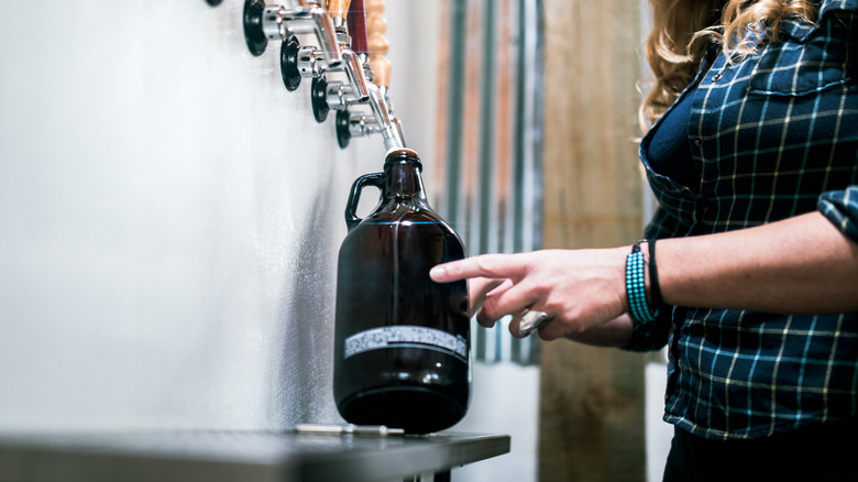 Woman filling growler from tap