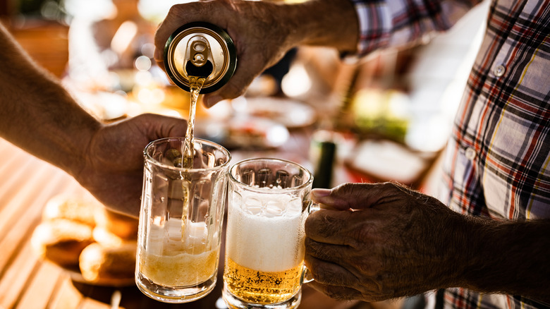 Person pouring beer into glass