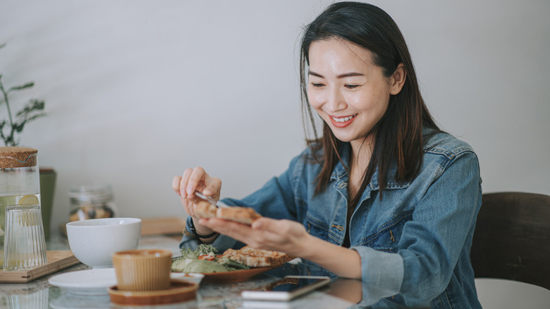 woman spreading butter on toast