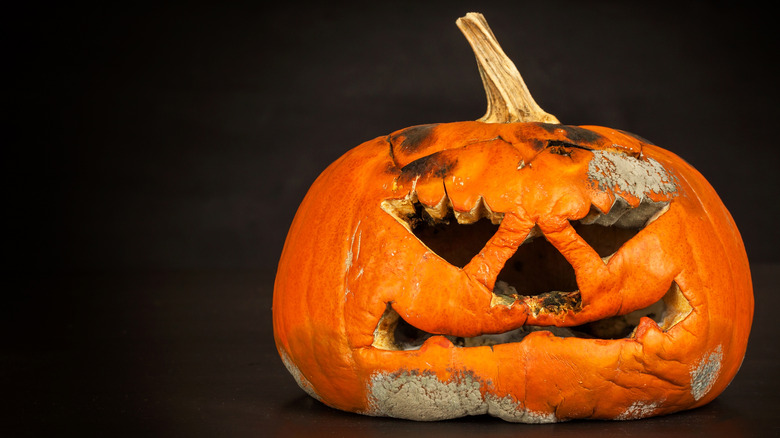 Carved pumpkin showing signs of rot