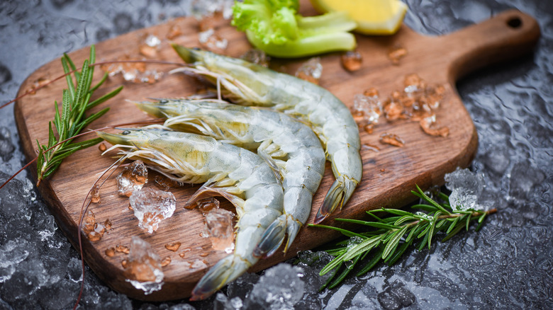 Raw shrimp on cutting board