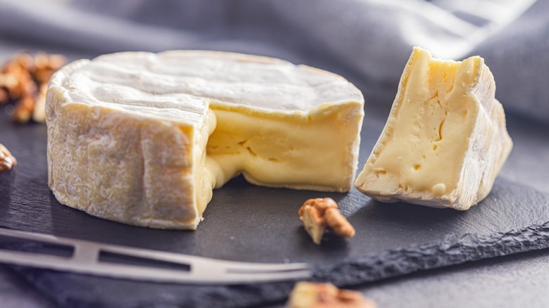 wedge of brie on a slate board