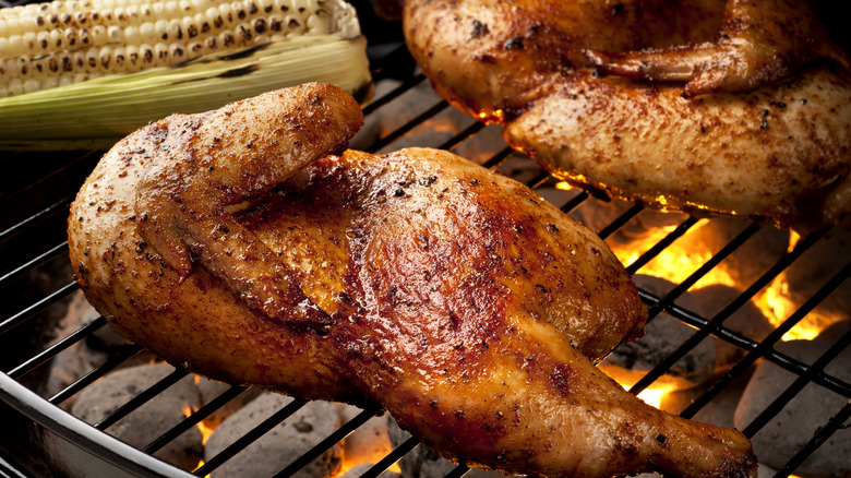 chicken legs on grill with corn