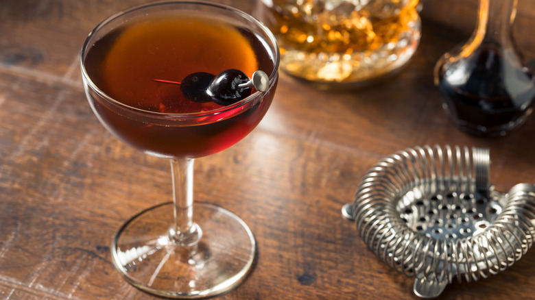 Cocktail garnished with maraschino cherries