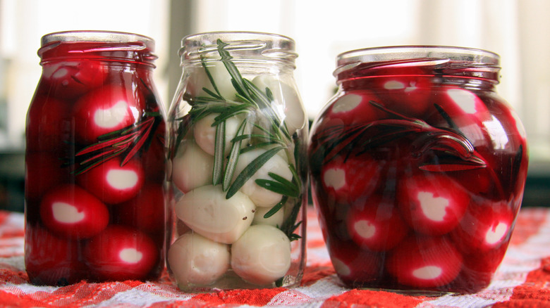 pickled eggs in open jars