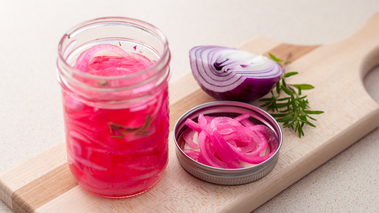 pickled red onions with jar of brine