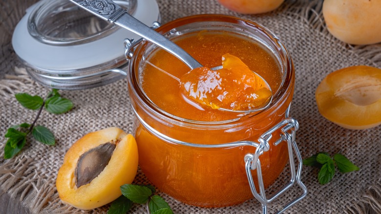 Open jar of apricot jelly