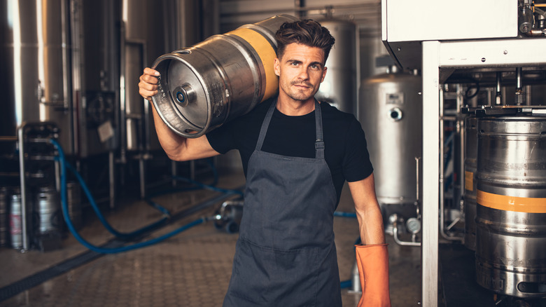 Brewer holding a keg