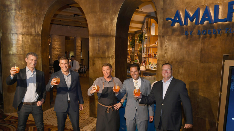 bobby flay standing in front of amalfi restaurant