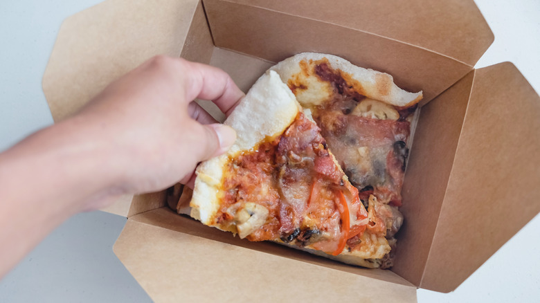 leftover pizza in takeout container