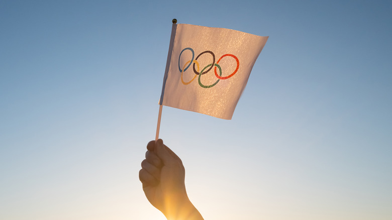 Someone holding an Olympics flag