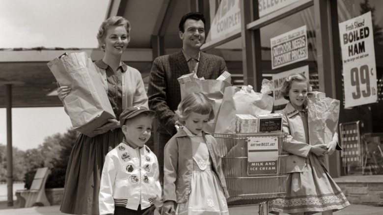 1950s family carrying groceries