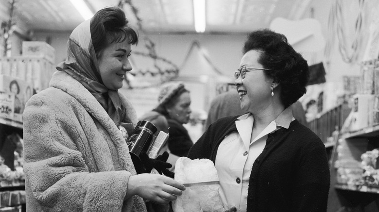 1950s women smiling in grocery store