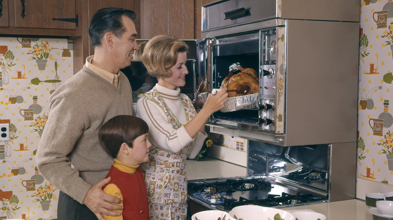 1960s family using oven