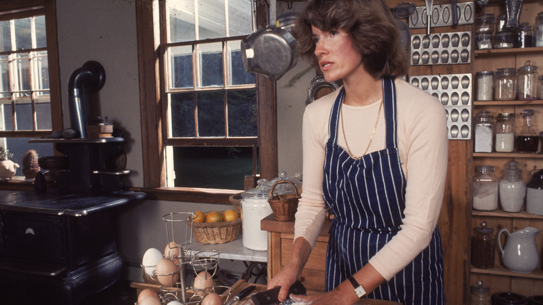 woman cooking in kitchen near eggs