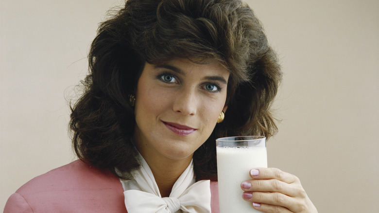 1980s woman holding glass of milk